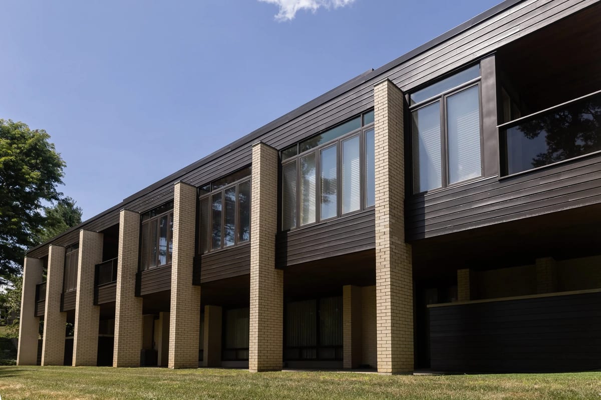 Commercial property with dark siding and brick columns painted by McHugh Painting