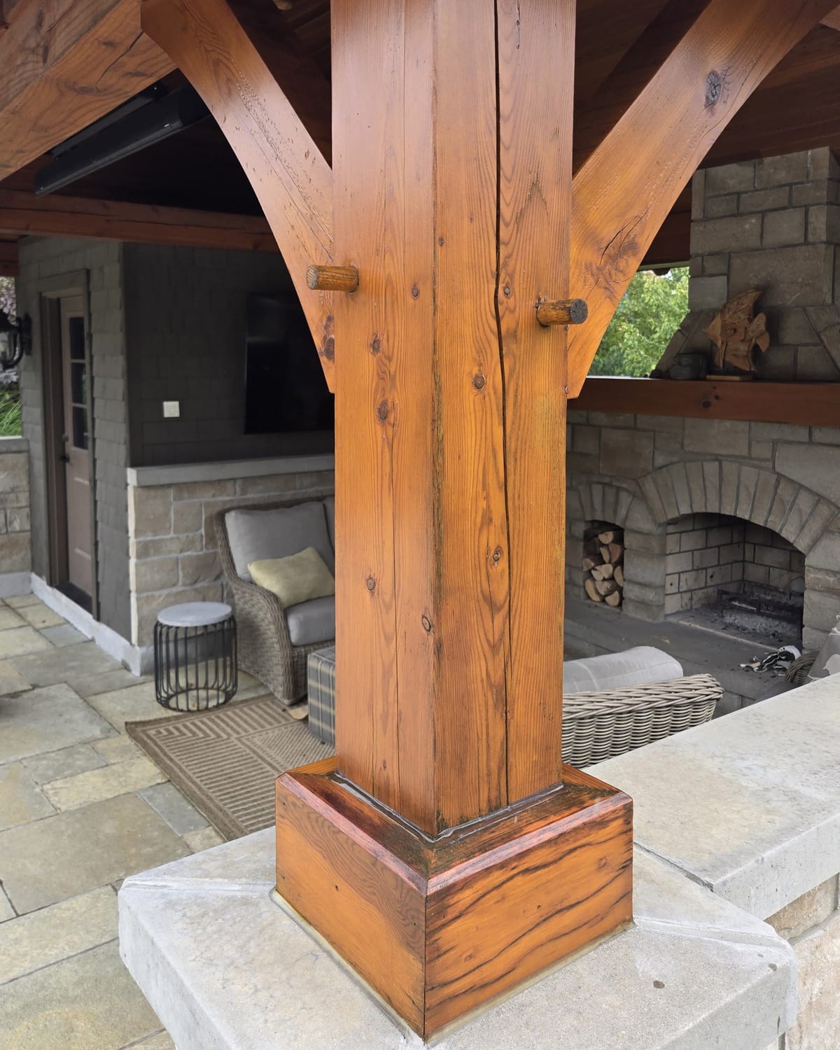 Refinished cedar timber post and beam on a backyard pergola